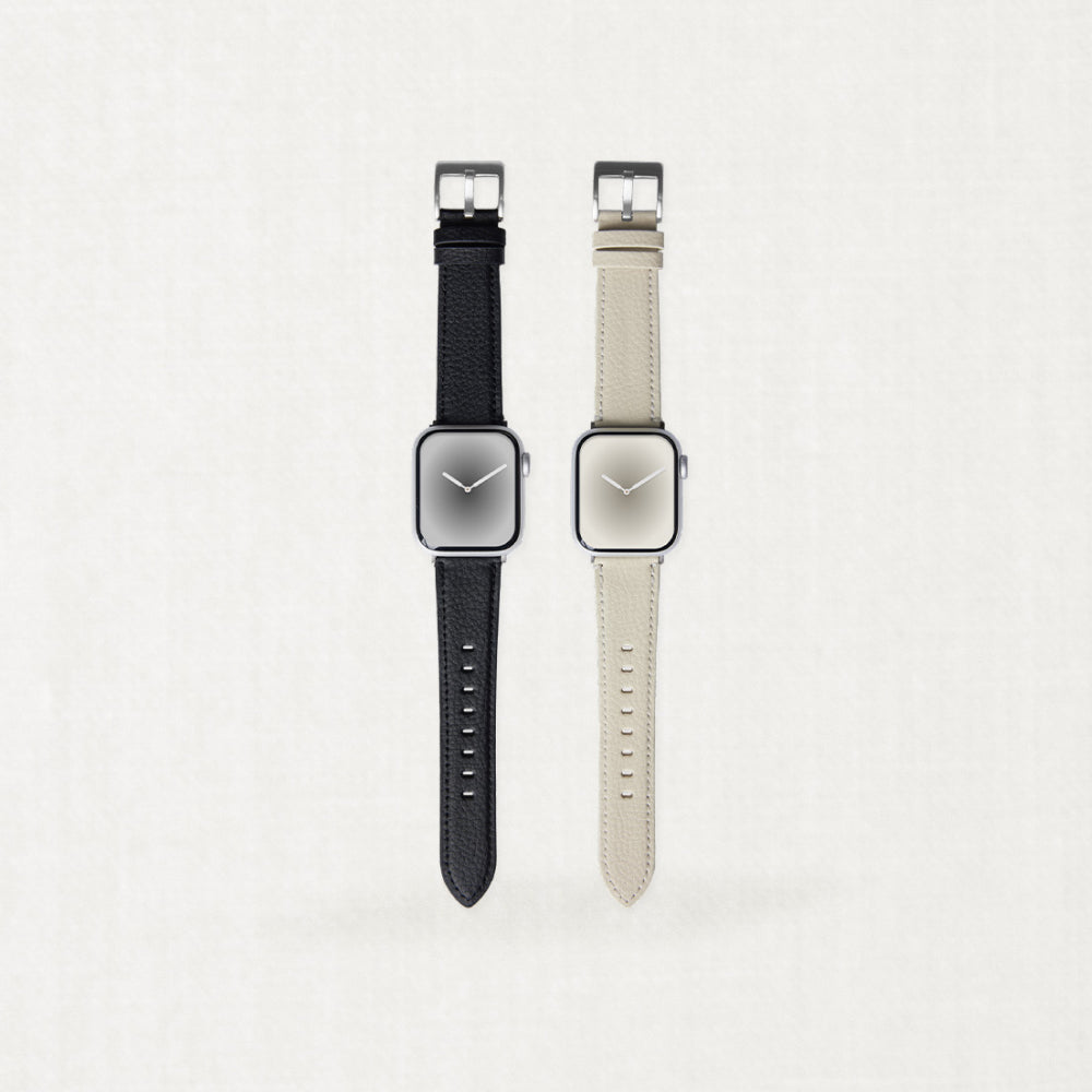 Two minimalist Labovarde Apple Watch bands made of sustainable corn-based bio-leather in black and warm beige, displayed side-by-side on a light neutral background