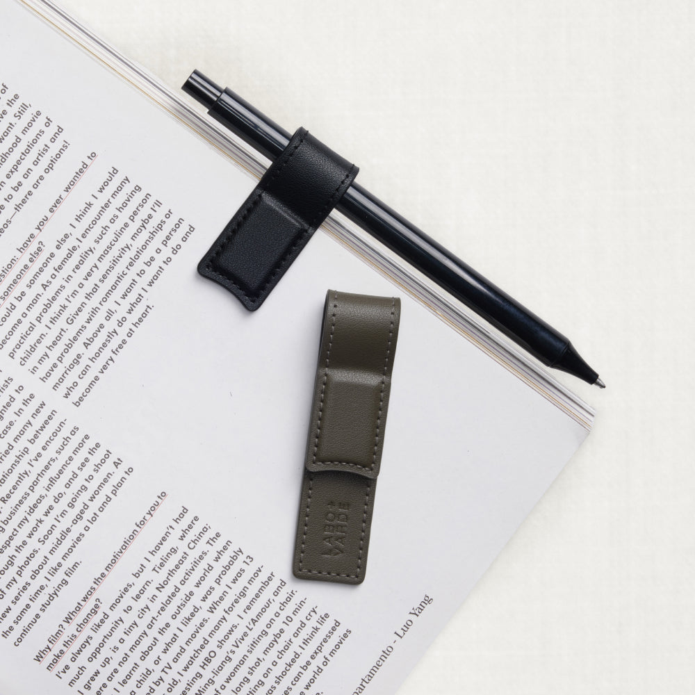Labovarde Book Clips in Black and Etoupe — Flat lay view on an open book page with a black pen