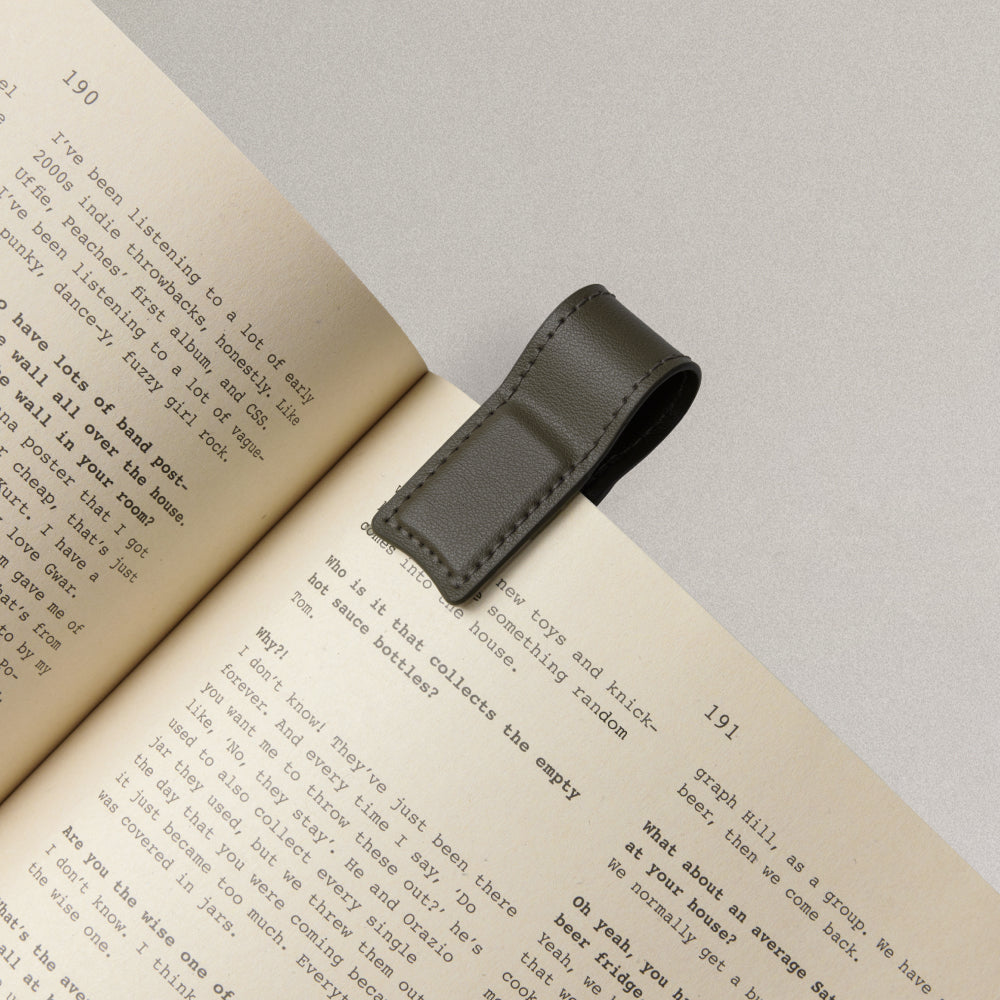 Labovarde Book Clip in Etoupe — Close-up view of the clip holding a page of a book