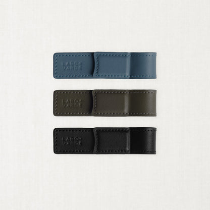 Labovarde Book Clips in Black, Etoupe, and Pale-Blue — Flat lay view showing the blind debossed logo and neat stitching