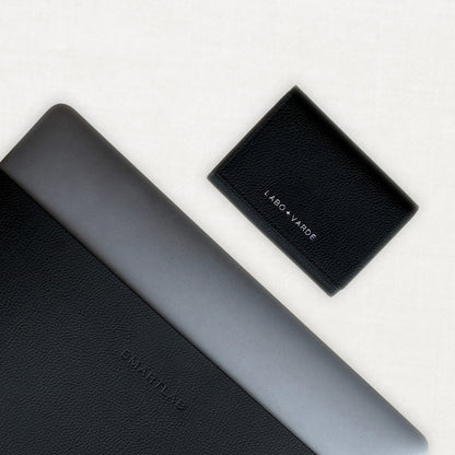 Labovarde Business Card Holder in Black — Flat lay view showing engraving logo detail and Laptop Sleeve in Black on a white background