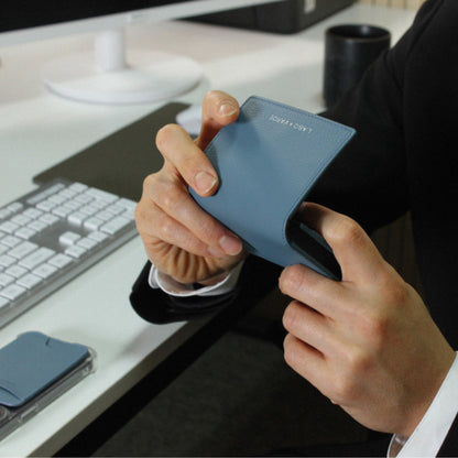 Labovarde Business Card Holder in Pale Blue — Close-up view of hands holding the case open at a modern office desk
