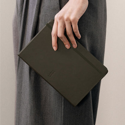 Labovarde Business Diary in Etoupe — Close-up view of a hand holding the closed diary