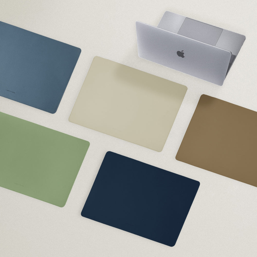 Labovarde Laptop Sleeve in Assorted Colors — Top view of sleeves in 5 colors next to a MagBook on a white background