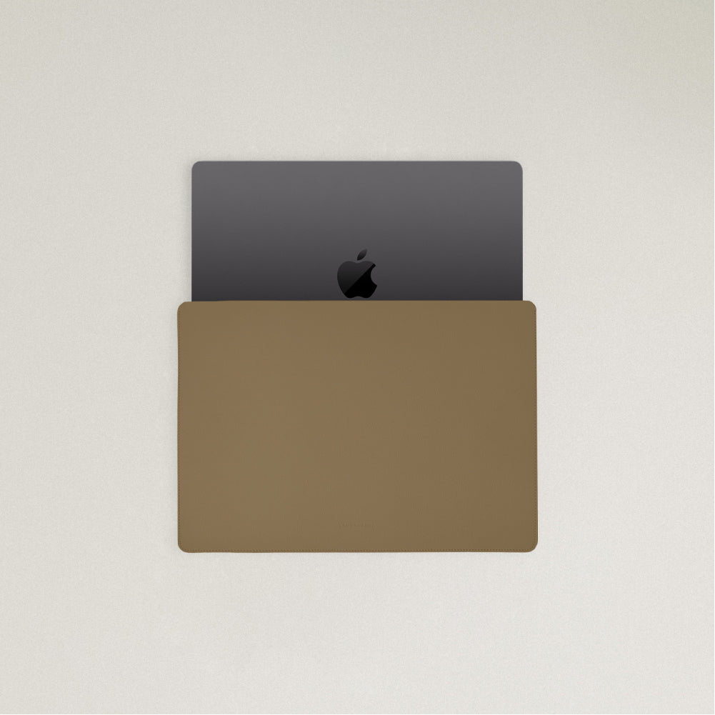 Labovarde Laptop Sleeve in Camel Brown — Top view with a space gray MacBook partially inserted to show the sleek fit
