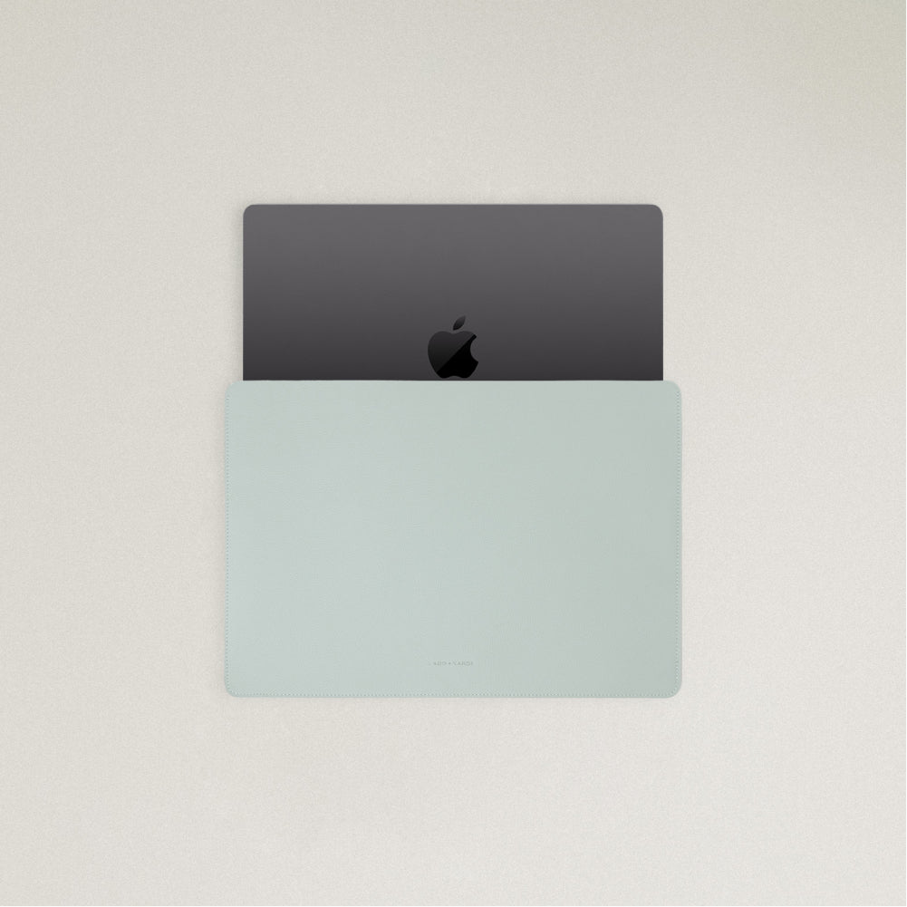 Labovarde Laptop Sleeve in Clear Blue — Top view with a space gray MacBook partially inserted to show the sleek fit