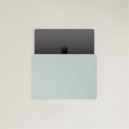 Labovarde Laptop Sleeve in Clear Blue — Top view with a space gray MacBook partially inserted to show the sleek fit