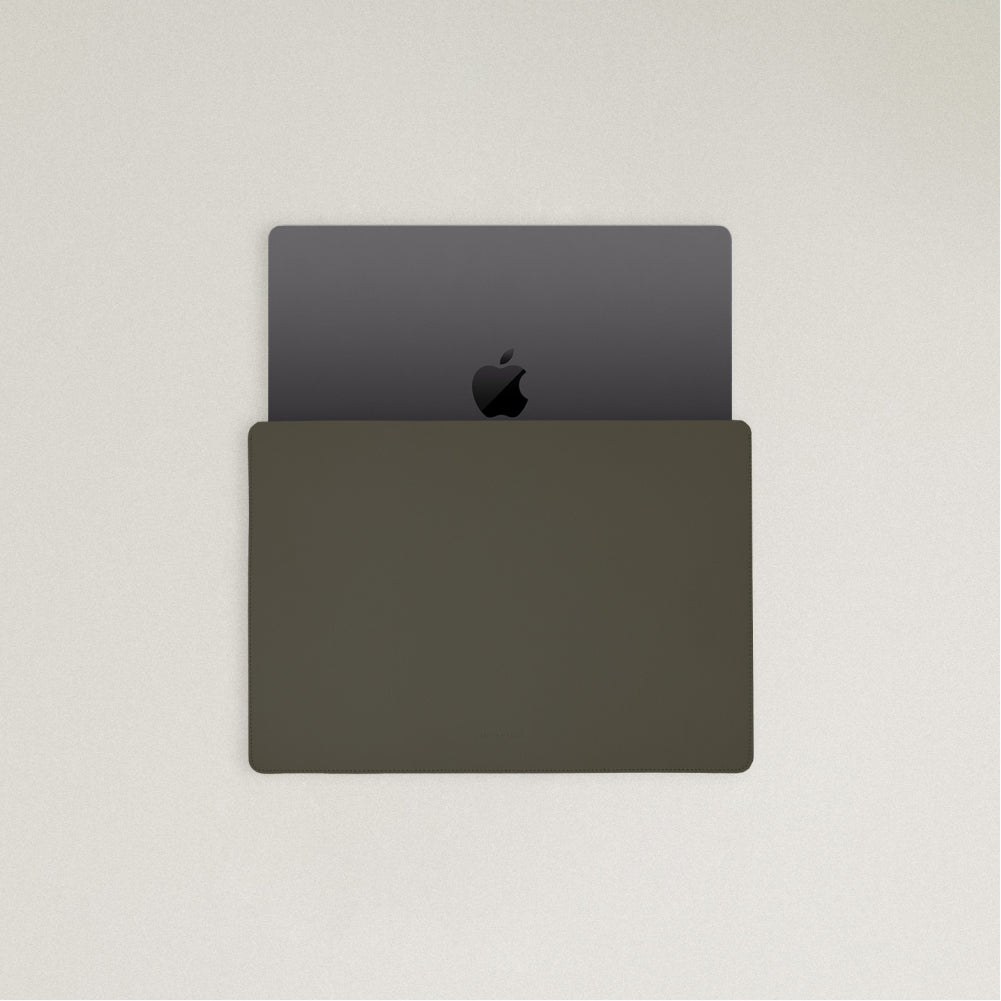 Labovarde Laptop Sleeve in Etoupe — Top view with a space gray MacBook partially inserted to show the sleek fit