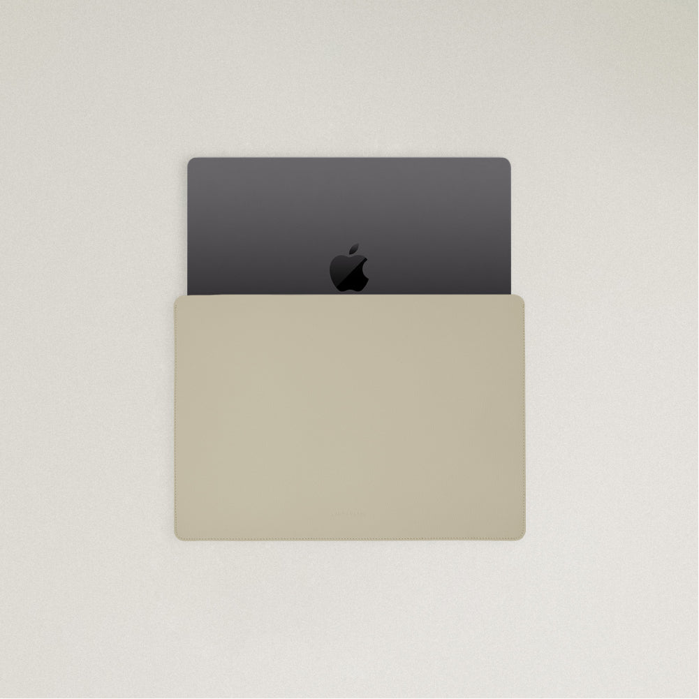 Labovarde Laptop Sleeve in Sand Gray — Top view with a space gray MacBook partially inserted to show the sleek fit
