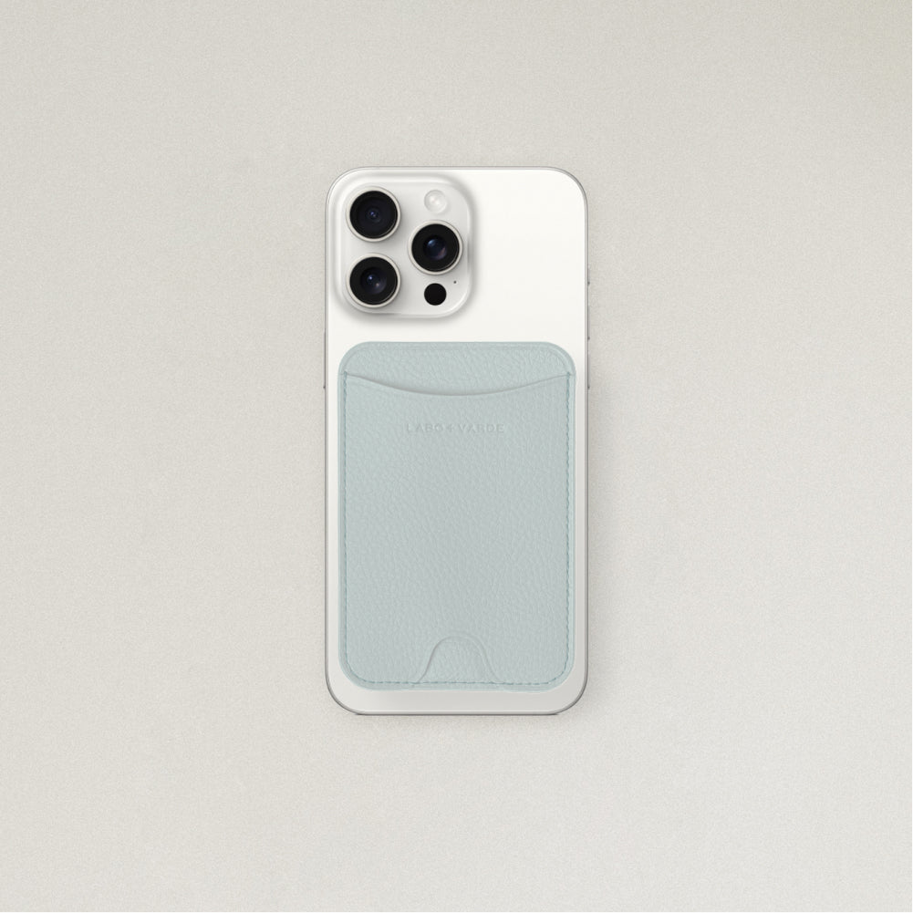 Labovarde MagSafe Card Wallet in Clear Blue — Attached to a white iPhone, showing the magenetic fit and debossed logo