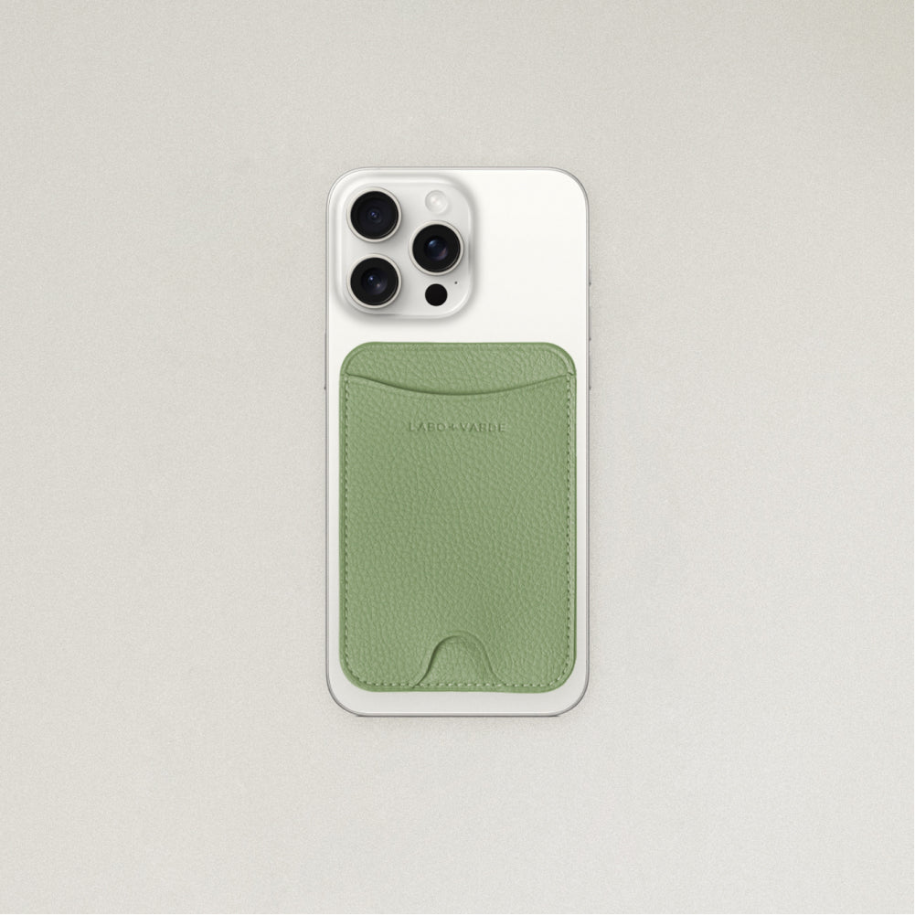 Labovarde MagSafe Card Wallet in Sage Green — Attached to a white iPhone, showing the magenetic fit and debossed logo
