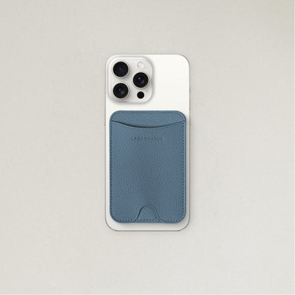 Labovarde MagSafe Card Wallet in pale-blue — Attached to a white iPhone, showing the magenetic fit and debossed logo