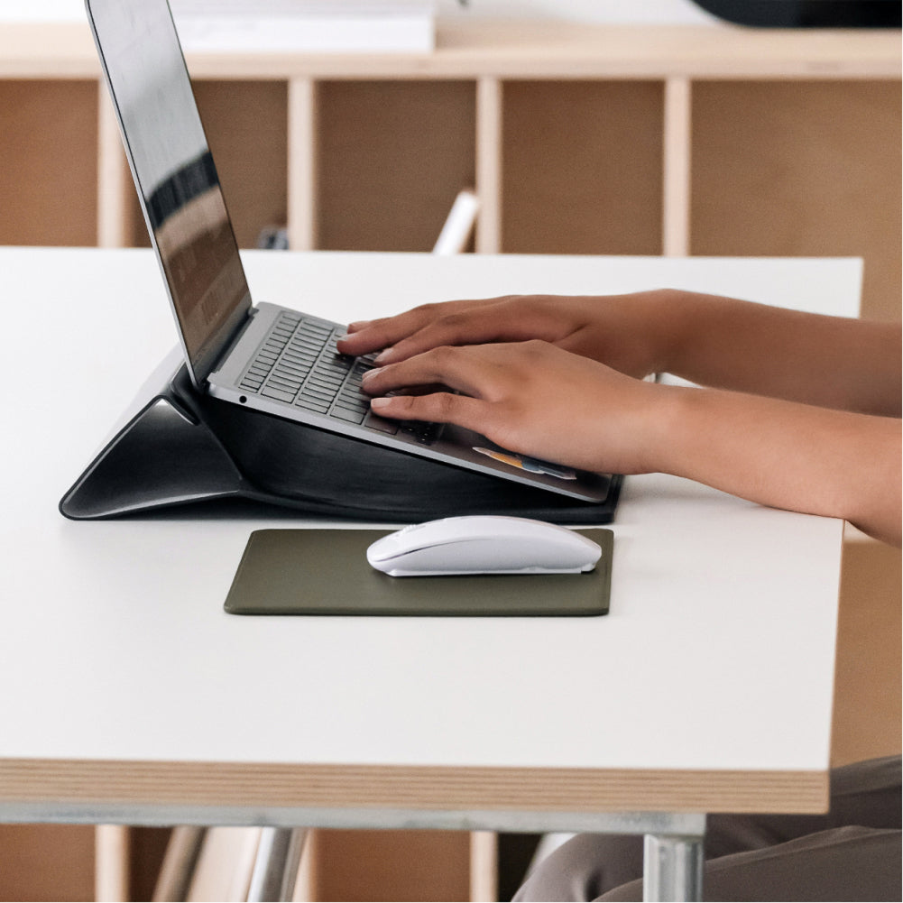 Labovarde Mouse Pad in Etoupe — Side view of the Mouse Pad next to hands typing on an elevated laptop