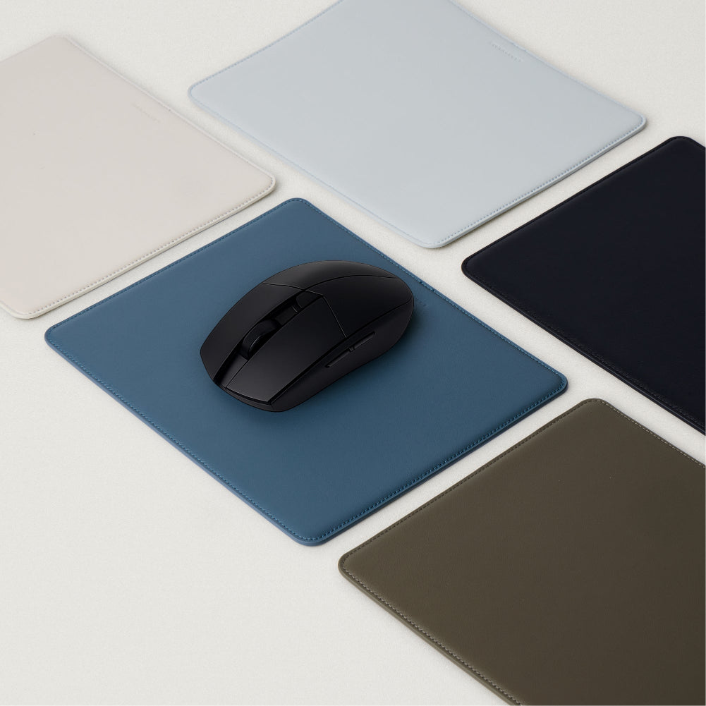 Labovarde Mouse Pad in Assorted Colors — With a black mouse on a pale-blue pad, surrounded by multi-color options