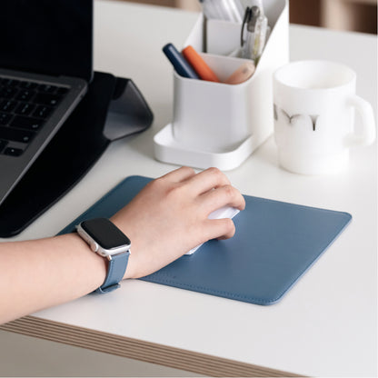 Labovarde Mouse Pad in Pale-Blue — Perspective view of a hand using a white mouse on the pad on a white desk