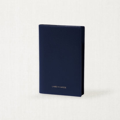 Labovarde Passport Case in Navy — Perspective view of the closed case standing on a minimalist textured white background