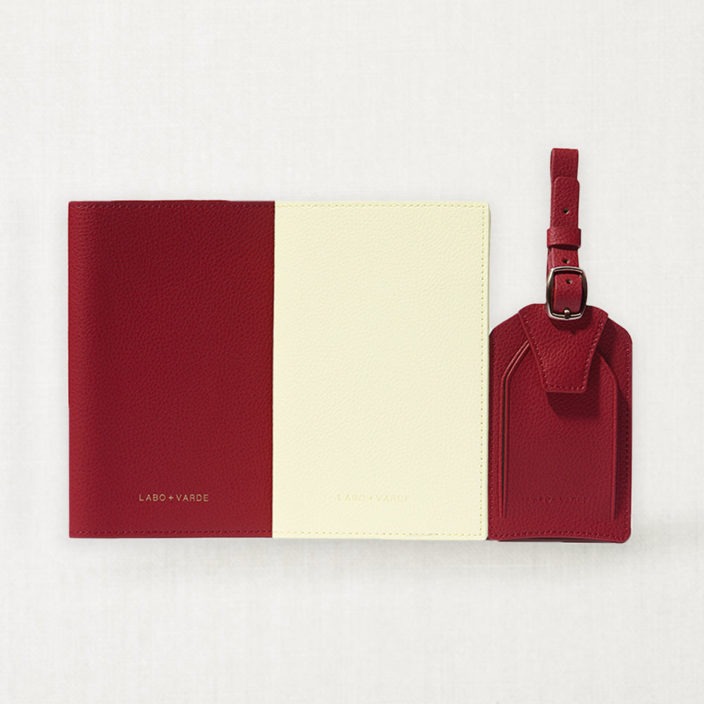 Labovarde Passport Cases and Name Tag — Flat lay view of red and ivory cases with a red name tag on a white background