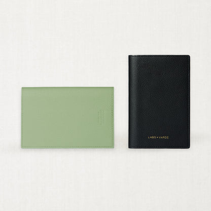 Labovarde Passport Cases — Flat lay view of closed Sage-green and black cases on a white background