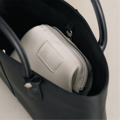 Labovarde Shell Pouch Bag in Light-Gray — Close-up view of a  leather bag inside a black handbag